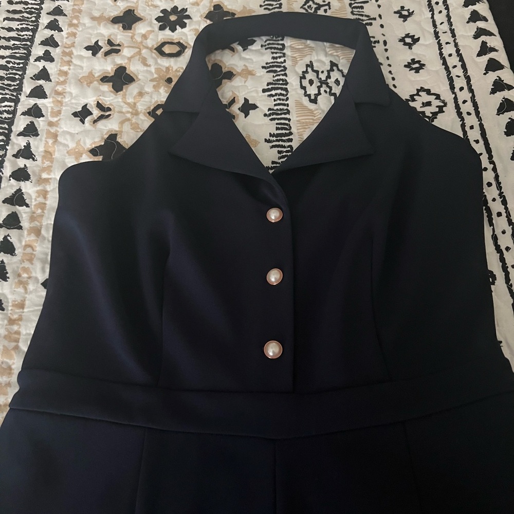 Stylish halter jumpsuit. Pearl detail buttons.